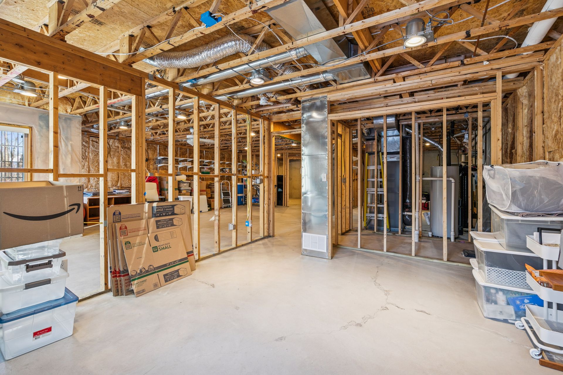 Unfinished lower level provides additional space ready for a second bedroom, and bathroom